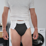 A man wearing a white incontinence diaper with snaps at the front for easy removal.